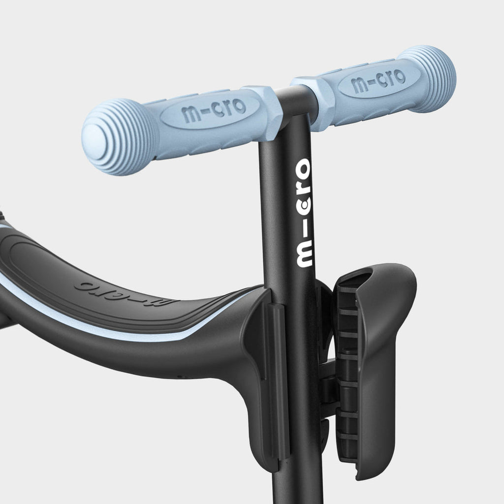 Close-up of the soft blue handlebar grips and black seat on the Micro Mini2Grow Deluxe