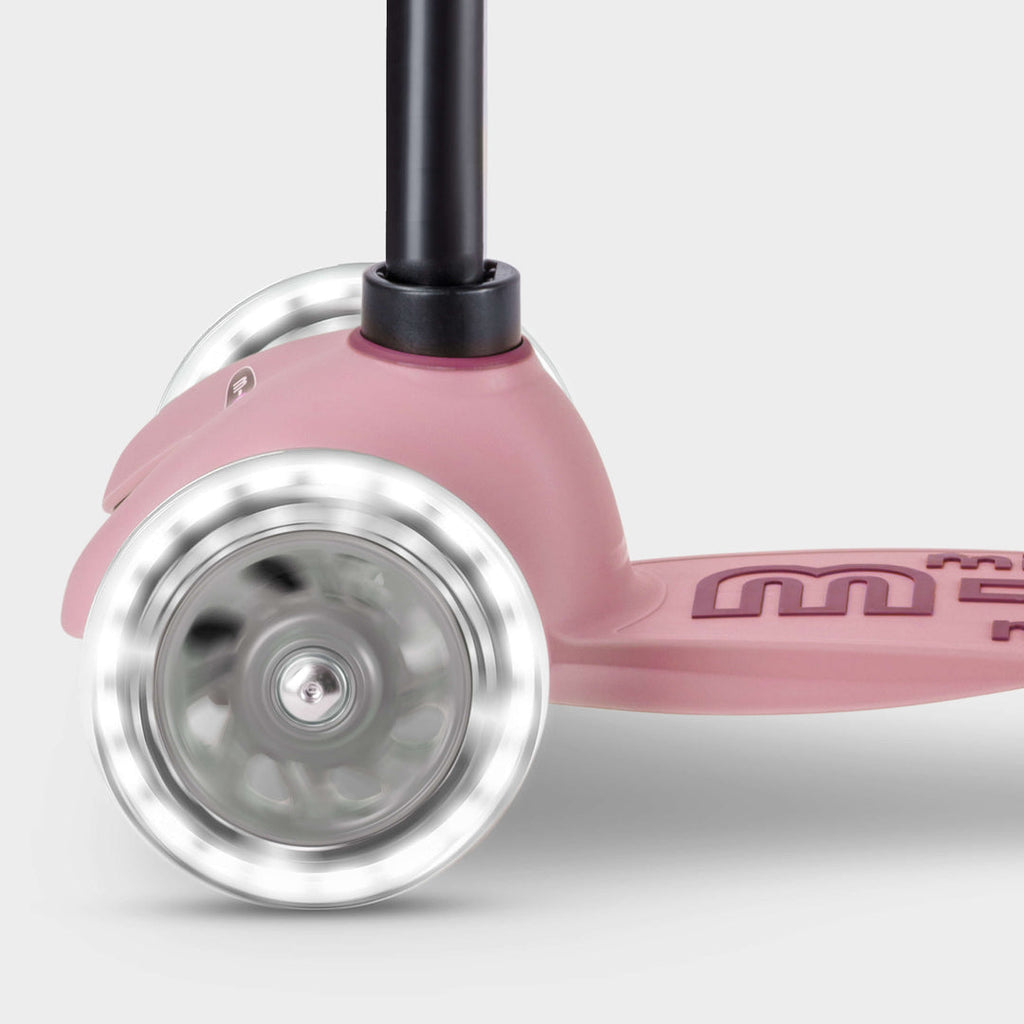 Close-up of the light-up LED front wheels on the rose pink Micro Mini2Grow Deluxe