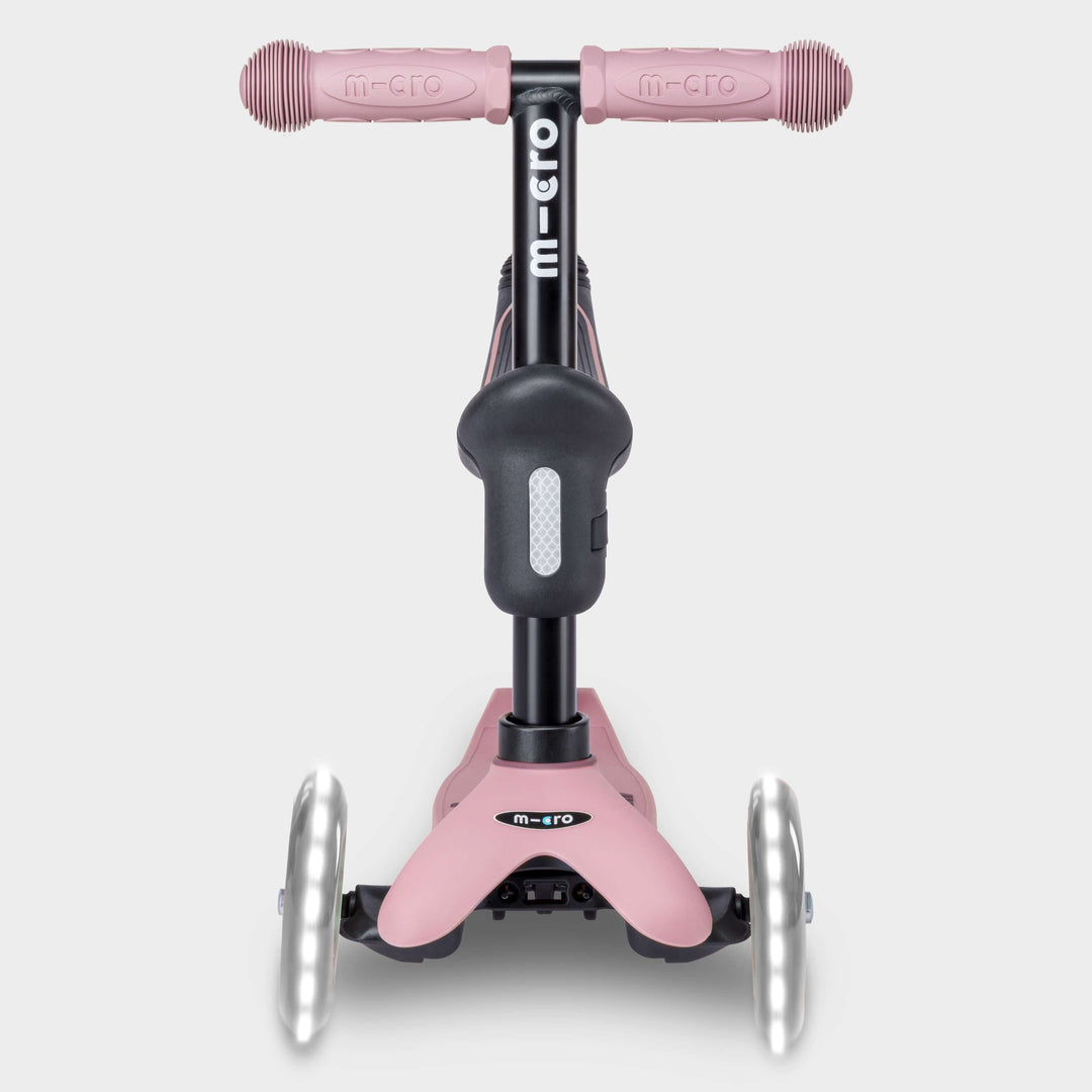 Front view of the rose pink Micro Mini2Grow Deluxe scooter with light-up front wheels