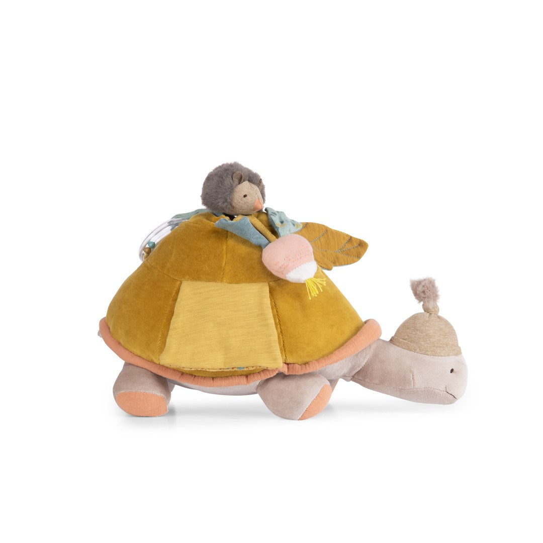 Moulin Roty large activity turtle side view showing the shell pocket, hedgehog and radish rattle