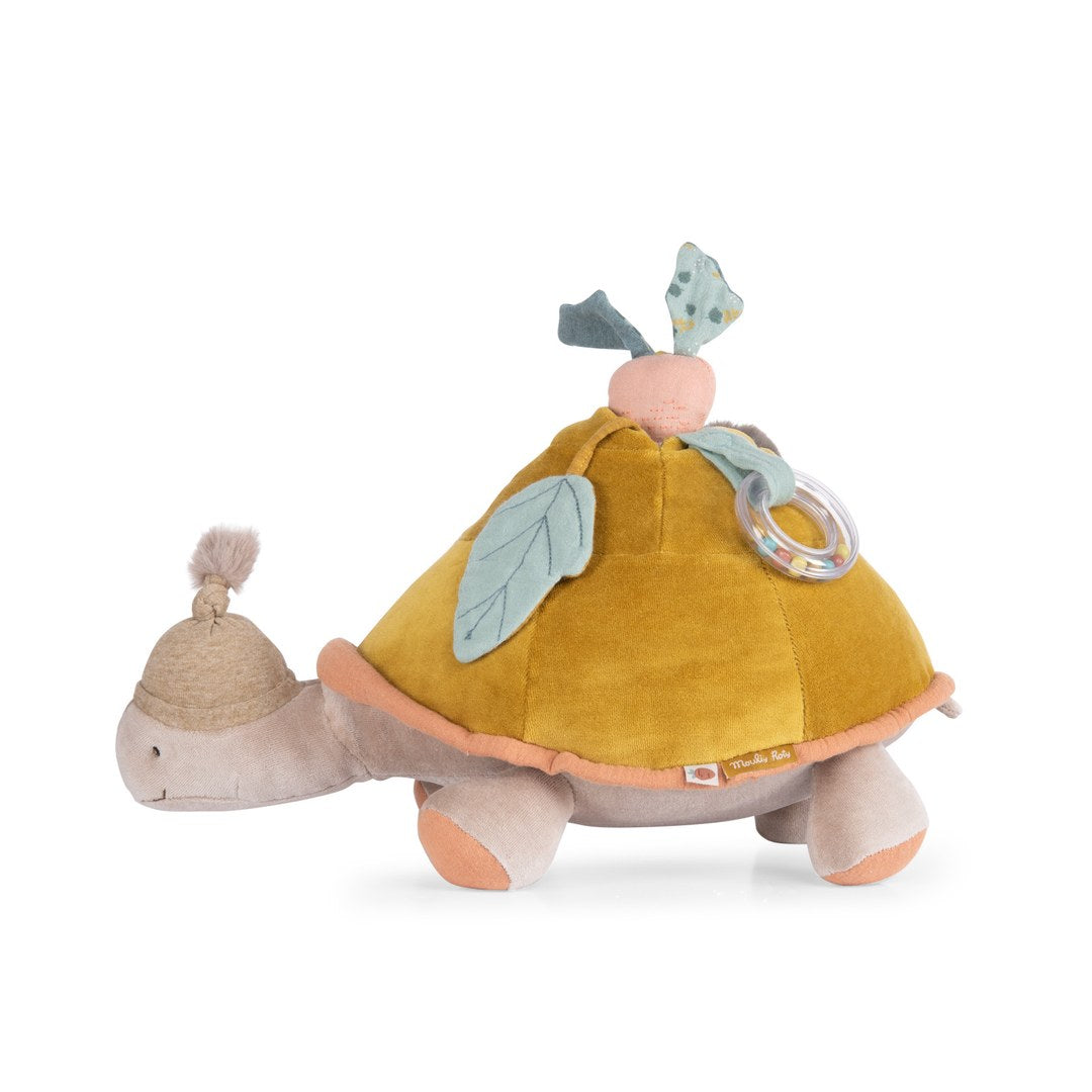 Moulin Roty large activity turtle side view with fabric leaves, radish and bead ring rattle