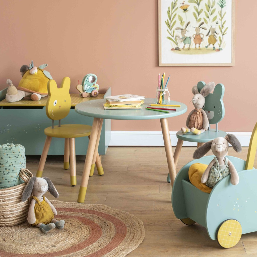 Moulin Roty activity turtle on a toy chest in a Trois Petits Lapins playroom with rabbit chairs and table