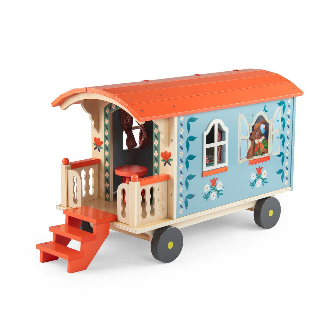 Moulin Roty wooden caravan three-quarter view from the balcony end with a bear at the window