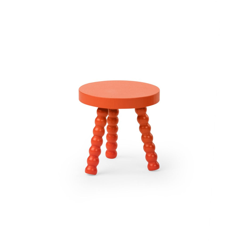 Red wooden stool included with the Moulin Roty caravan