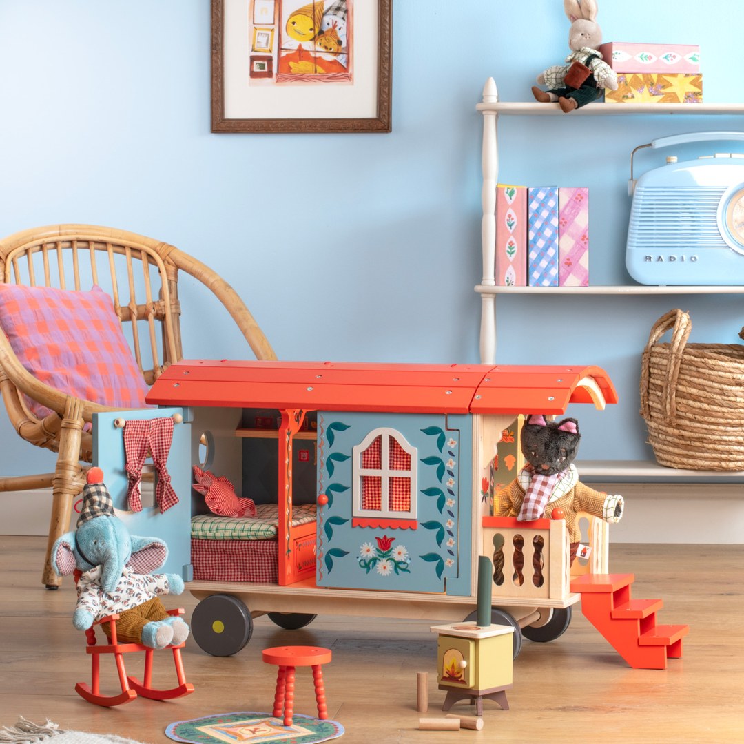 Moulin Roty wooden caravan in a child's playroom with Les Minouchkas animals