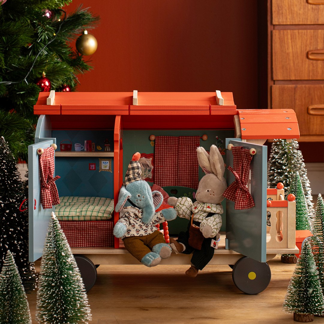 Moulin Roty caravan at Christmas with elephant and rabbit dolls among little fir trees
