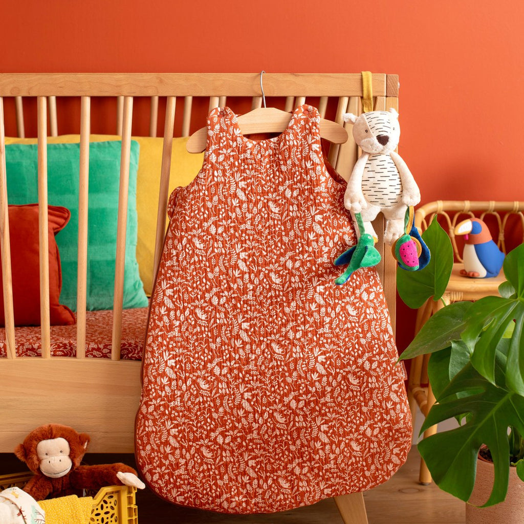 Moulin Roty activity tiger hanging on a cot in a nursery