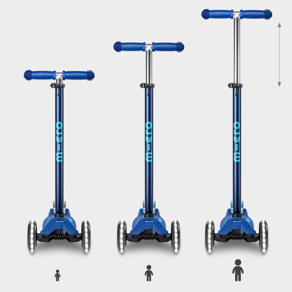 Three navy Maxi Micro Deluxe LED scooters showing the handlebar height adjusting as a child grows