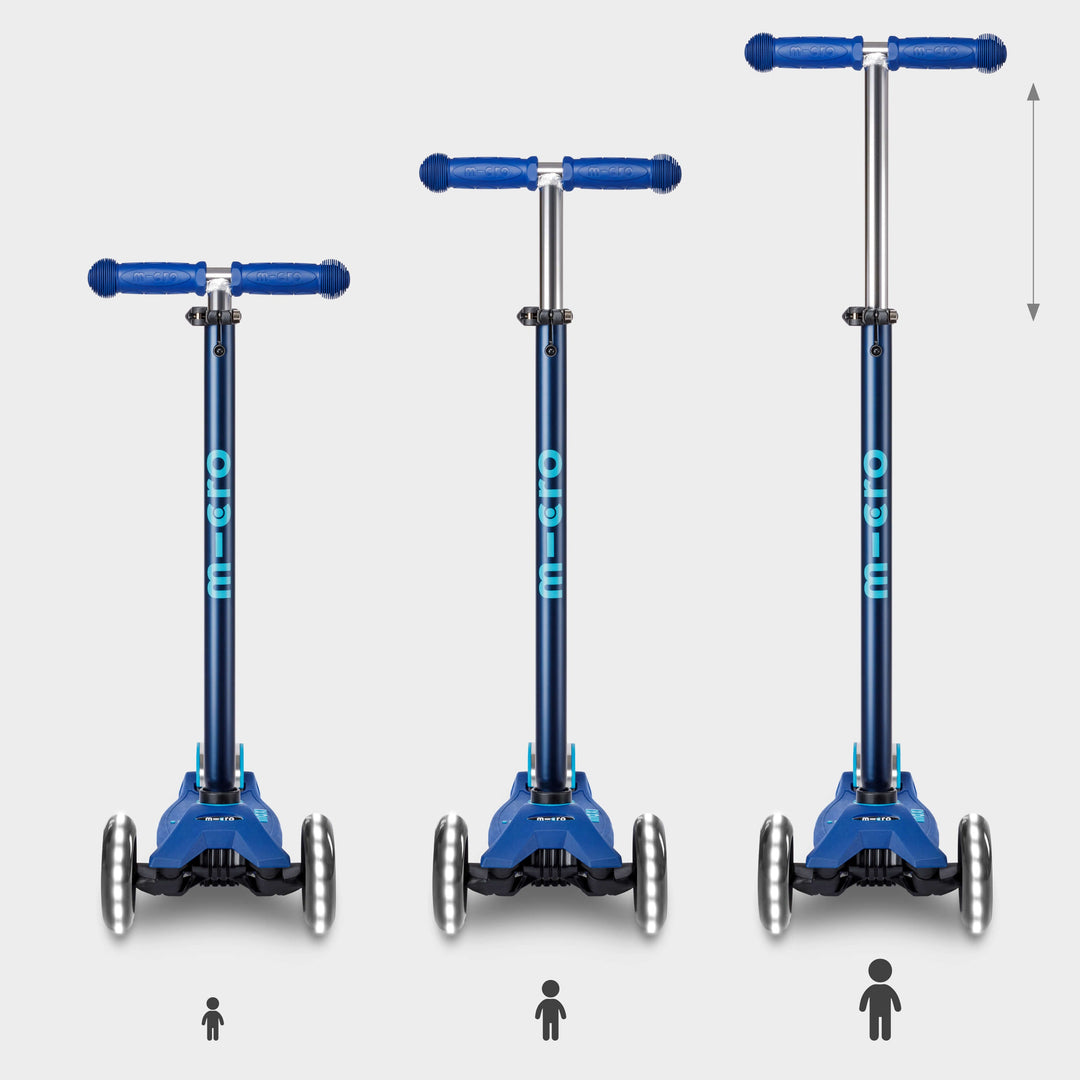 Three navy Maxi Micro Deluxe LED scooters showing the handlebar height adjusting as a child grows