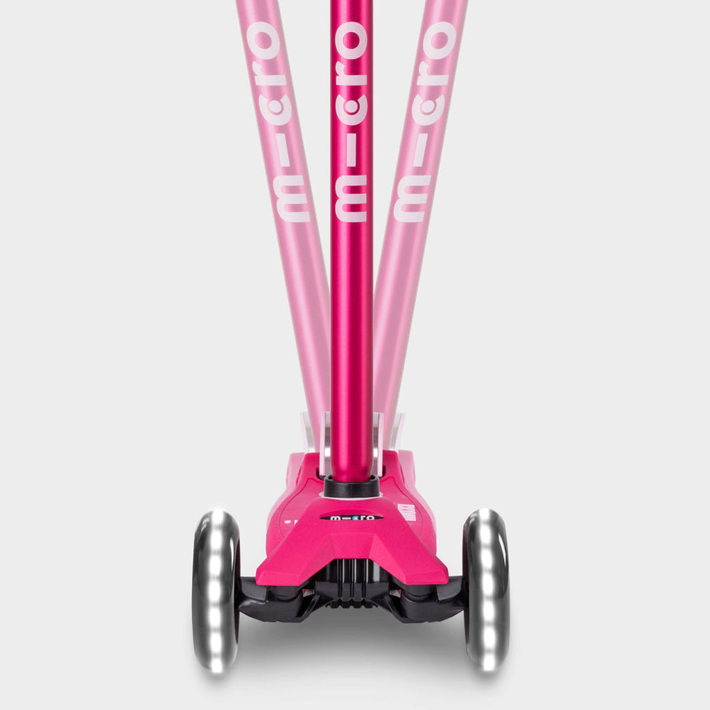 Front view of the pink Maxi Micro Deluxe LED handlebar tilting left and right to show lean-to-steer