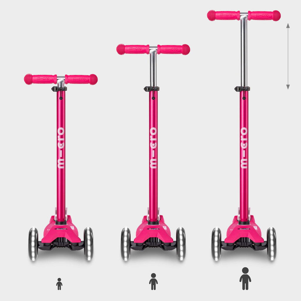 Three pink Maxi Micro Deluxe LED scooters showing the handlebar height adjusting as a child grows