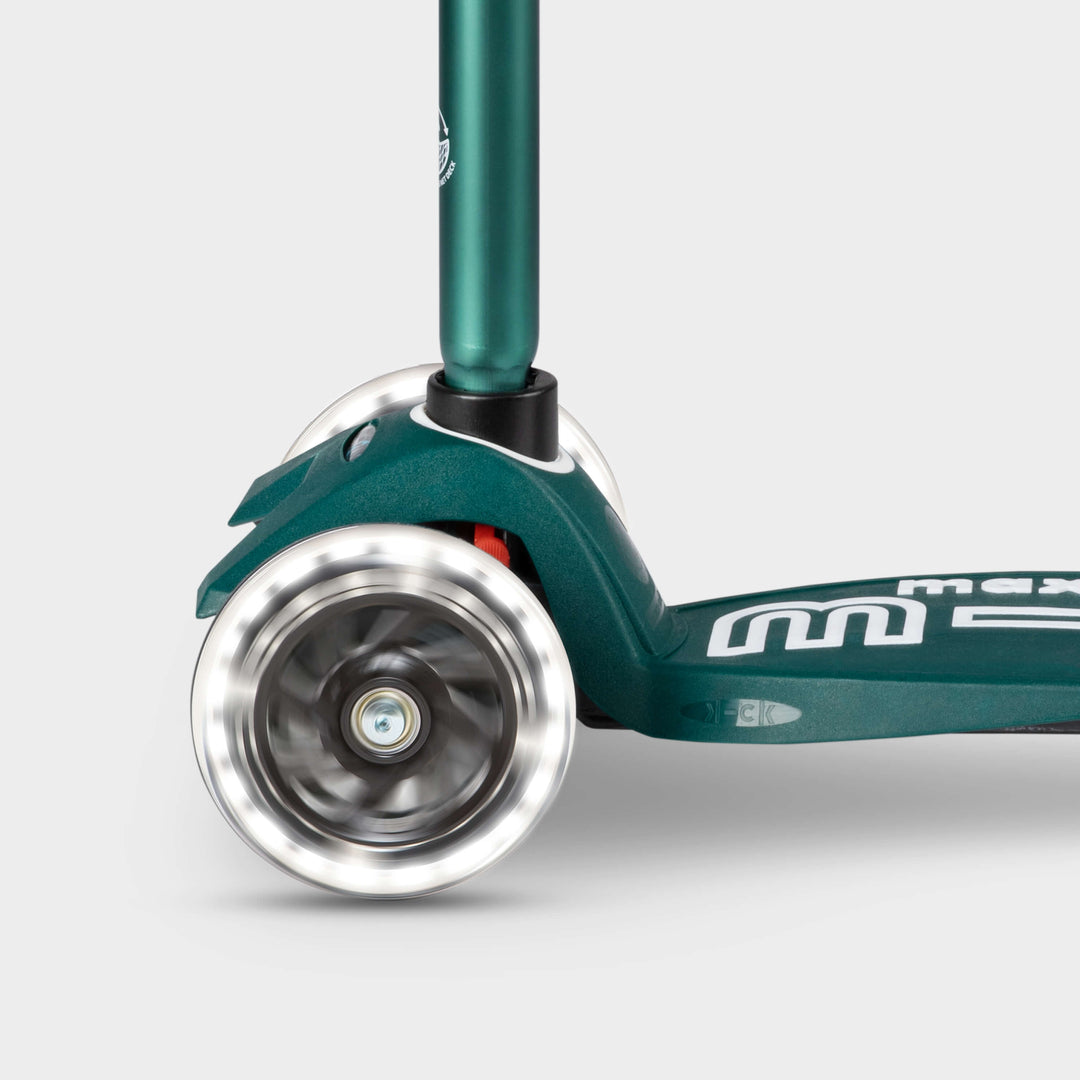 Close-up of the light-up LED front wheels on the green Maxi Micro Eco scooter