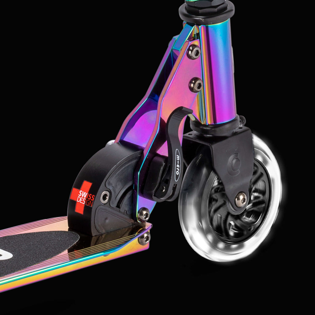 Close-up of the light-up front wheel and Neochrome folding mechanism on the Micro Sprite against a black background