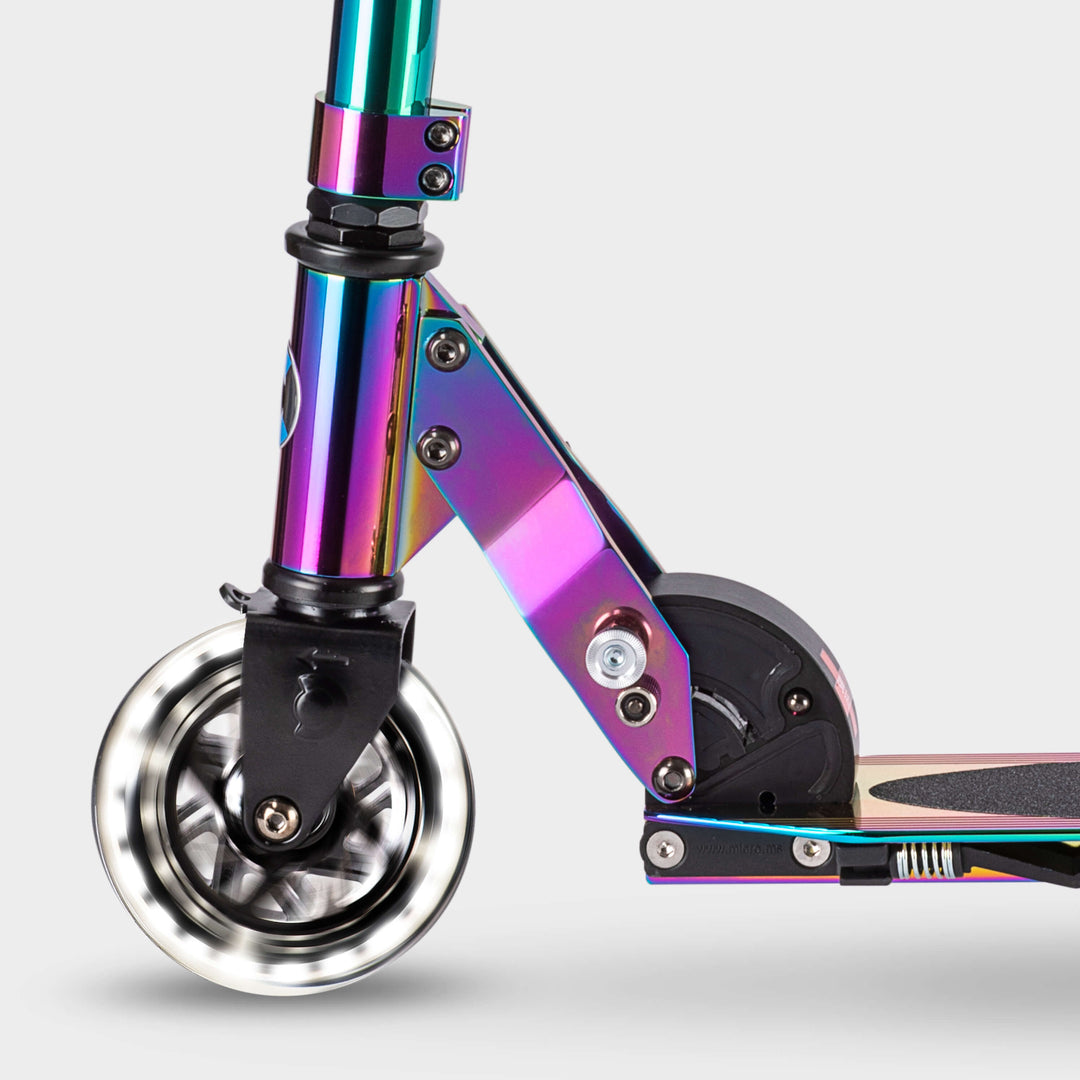Close-up of the light-up LED front wheel and folding mechanism on the Neochrome Micro Sprite scooter