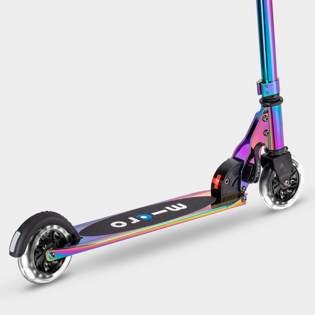 Neochrome Micro Sprite LED scooter showing the black deck with the micro logo and lit wheels