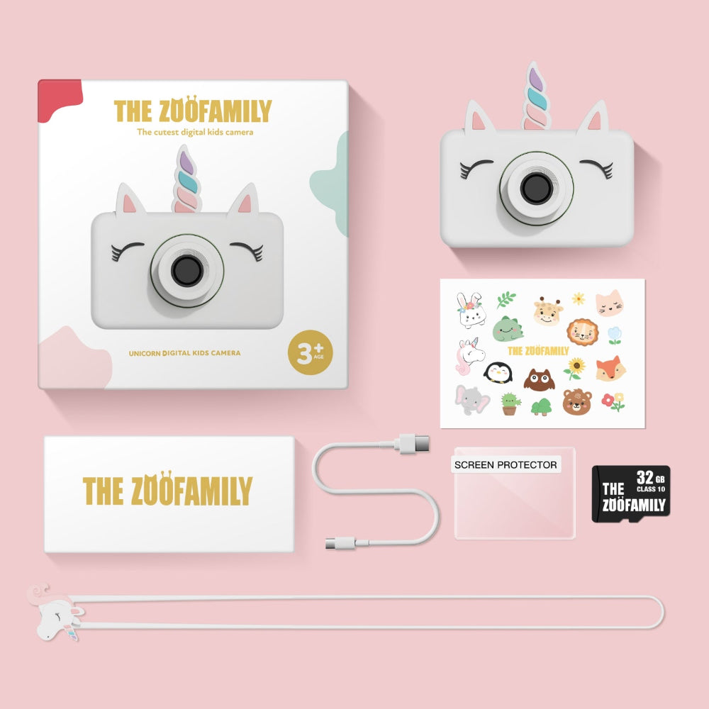 Unicorn digital photo camera with packaging, screen protector, and microSD card on a pink background