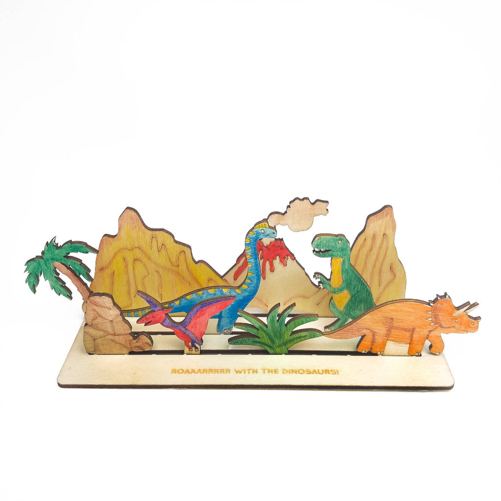 Wooden toy set with colorful dinosaurs and a landscape on a white background