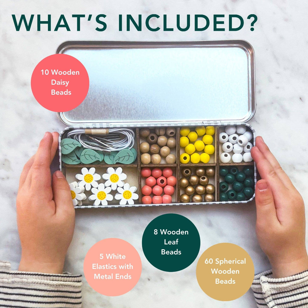 Open tin containing various beads and elastics with text indicating contents.