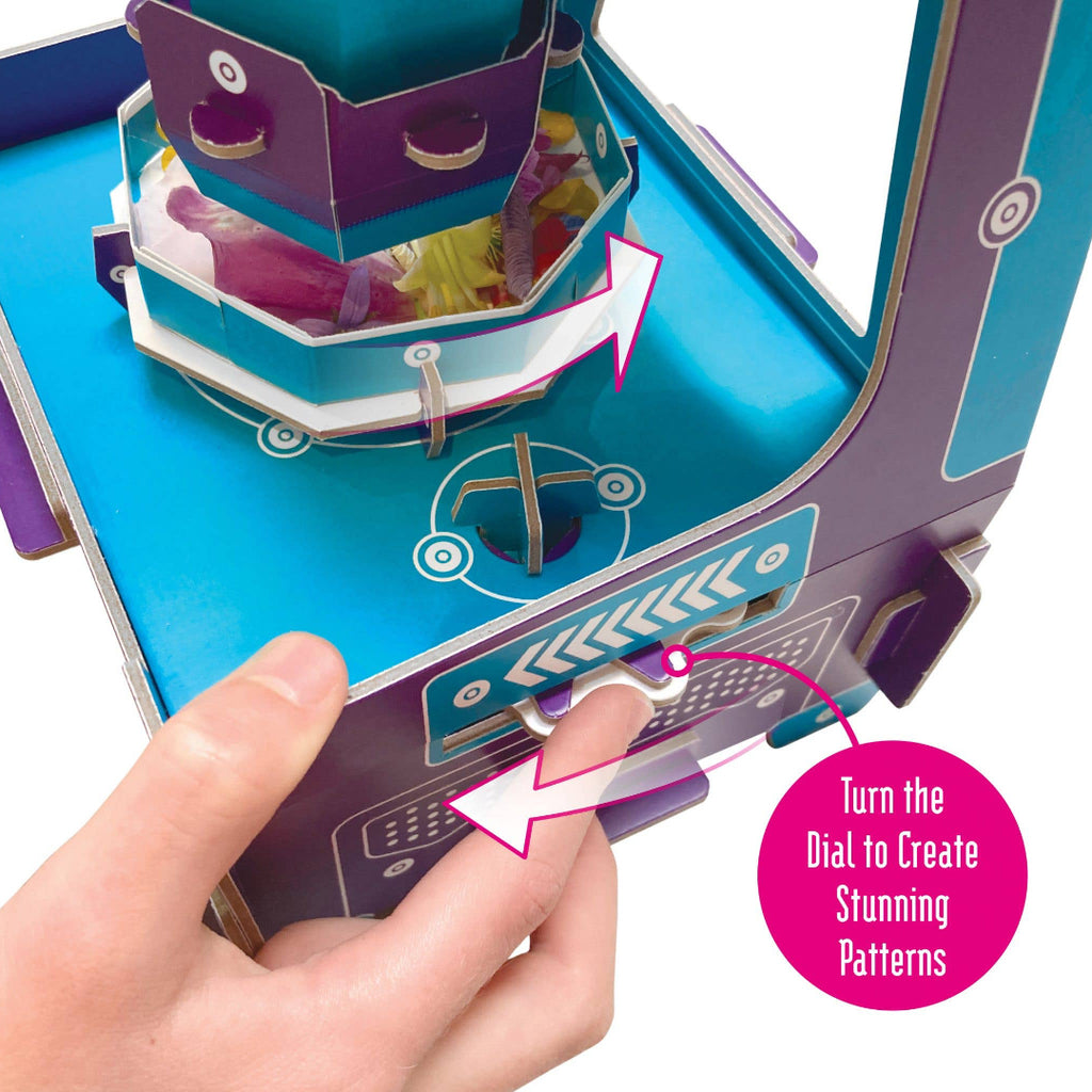 Hand holding a colorful paper craft with a dial, turning it to create patterns.