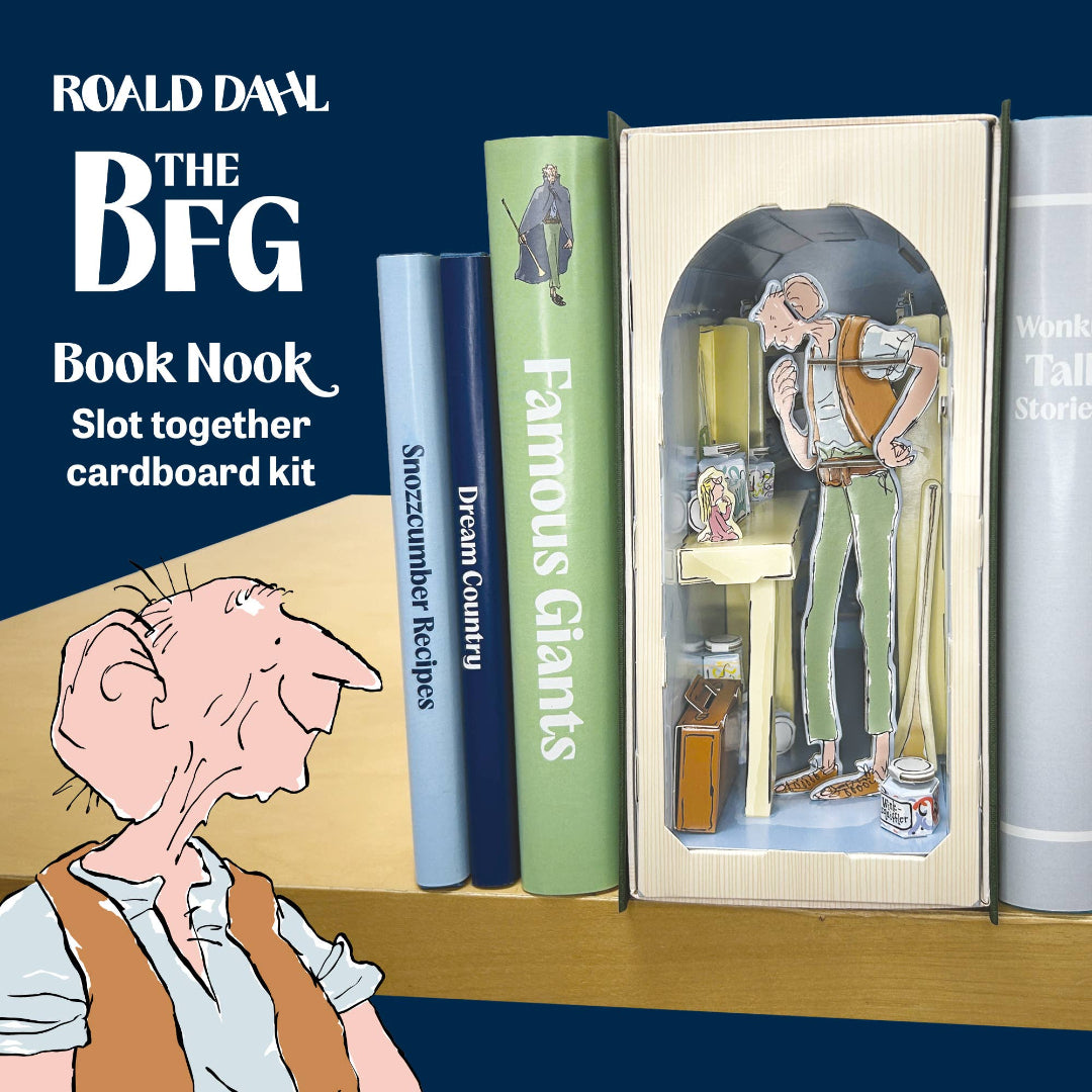 Roald Dahl 'The BFG' Book Nook slot together cardboard kit shown with the assembled cardboard BFG figure in a display box and several illustrated book spines on a shelf against a dark blue background.