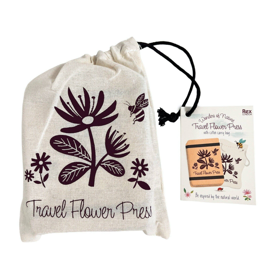 Travel flower press with floral design on a drawstring bag and product packaging.