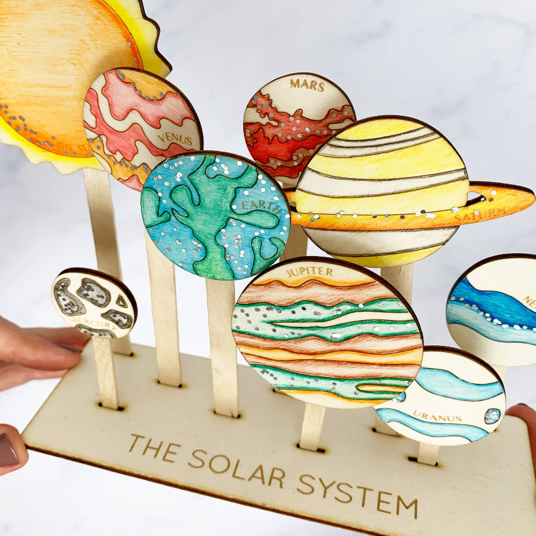 Model of the solar system with colorful planets on a stand.