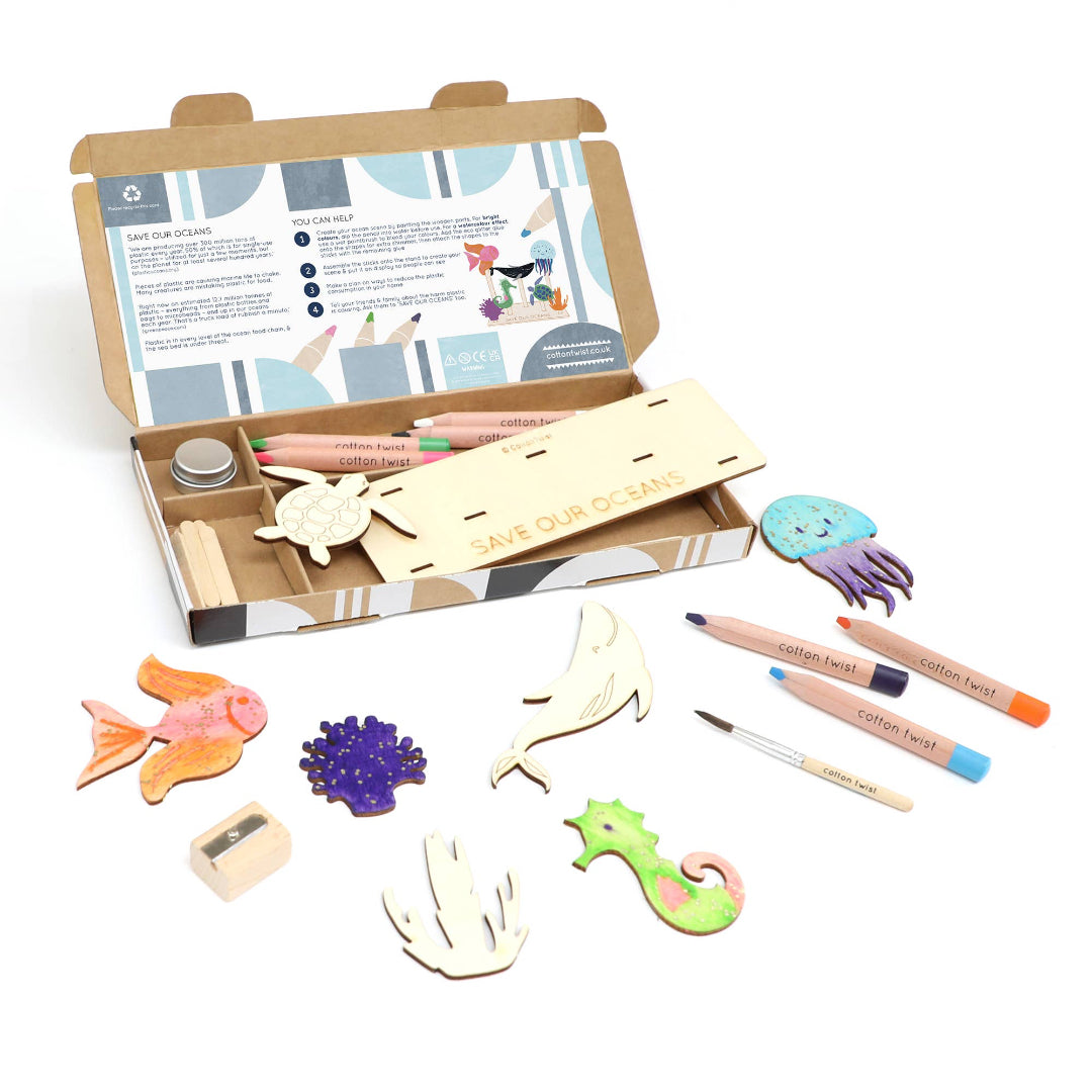 Children's craft kit with wooden shapes, markers, and instructions on a white background