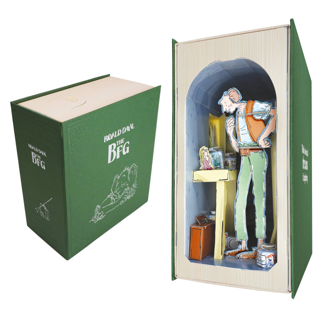 A boxed collectible or display set shown on a white background: a green box labeled 'Rolodex of the BFG' beside an open book-shaped display featuring a standing figure inside a cave-like archway with small accessories and a miniature scene.