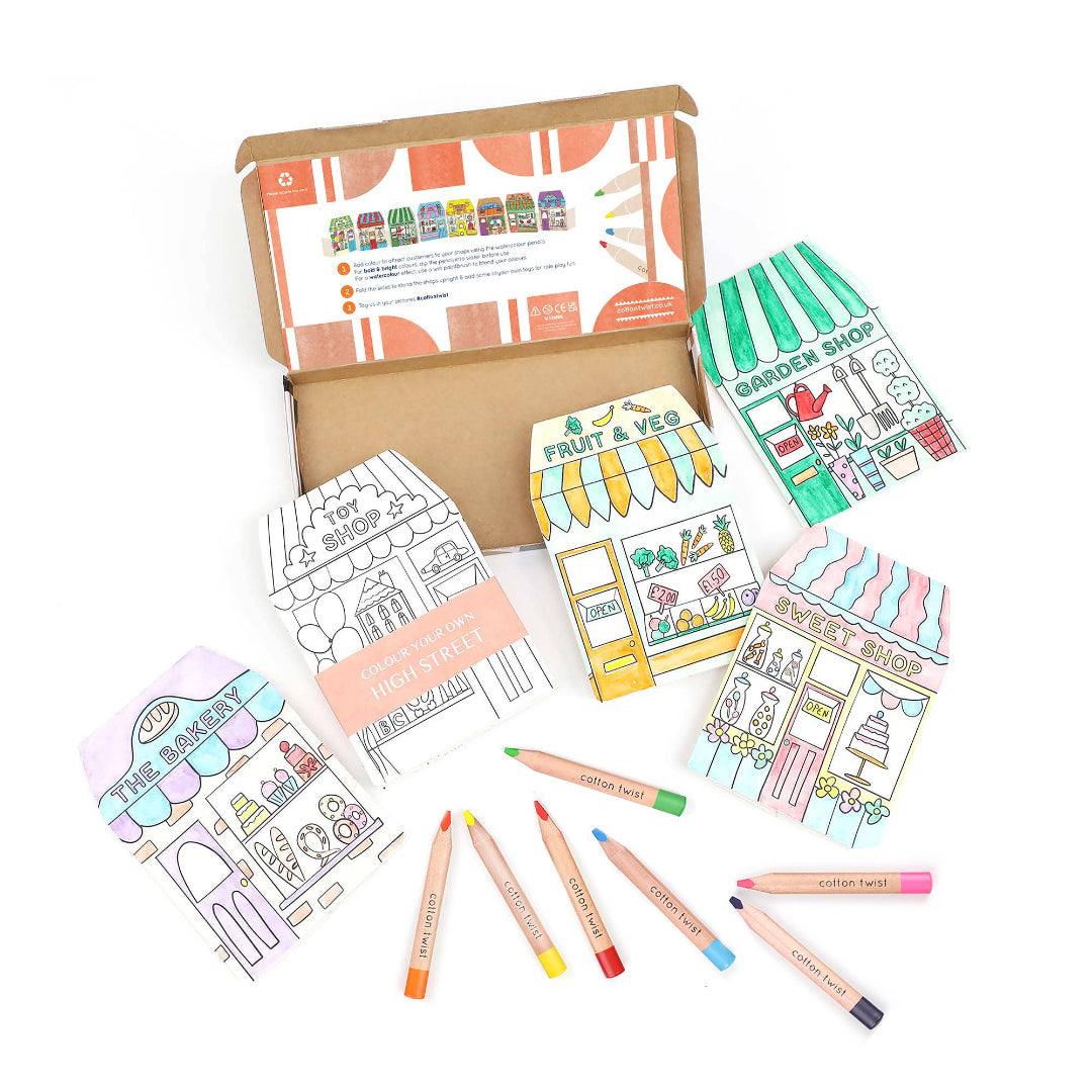 Colouring set with illustrations of shops and coloured pencils on a white background