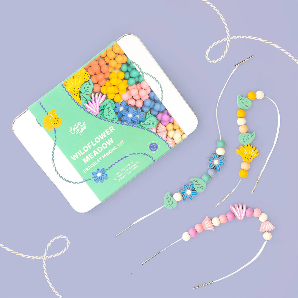 Cotton Twist Wildflower Meadow Bracelet Making Kit tin with two flower bead bracelets on a lilac background