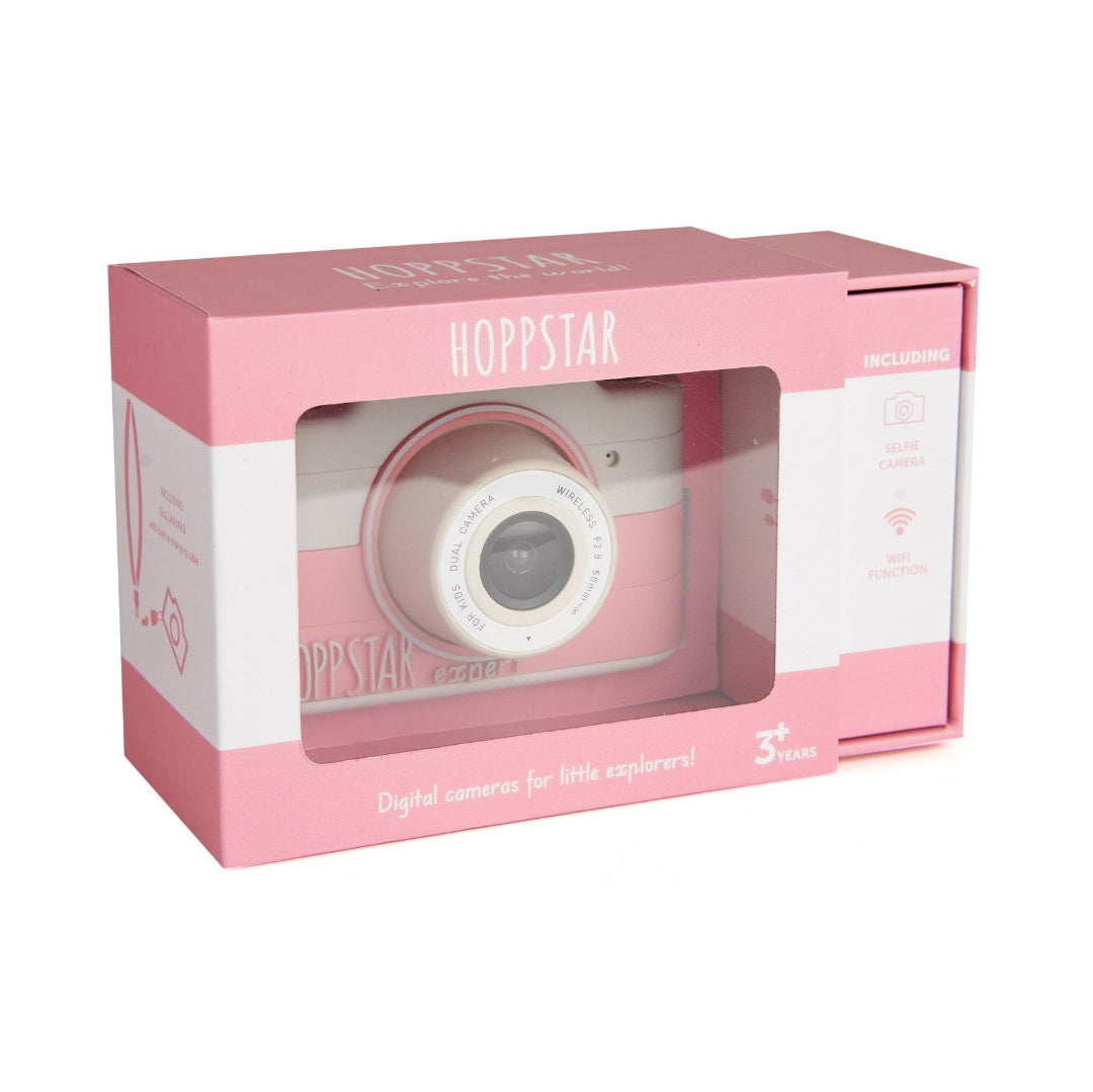 Pink Hoppstar digital camera toy in its original retail packaging, featuring a clear window that displays the toy camera inside.