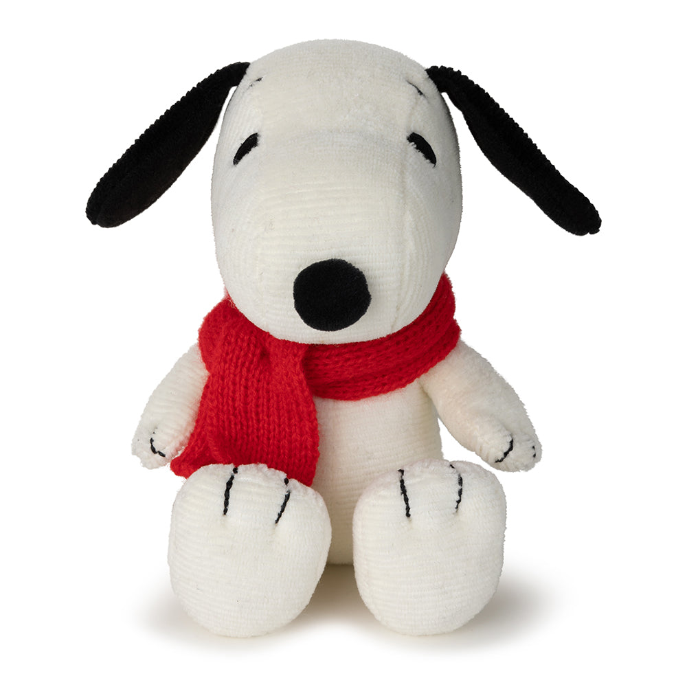 Stuffed dog toy with a red scarf on a white background