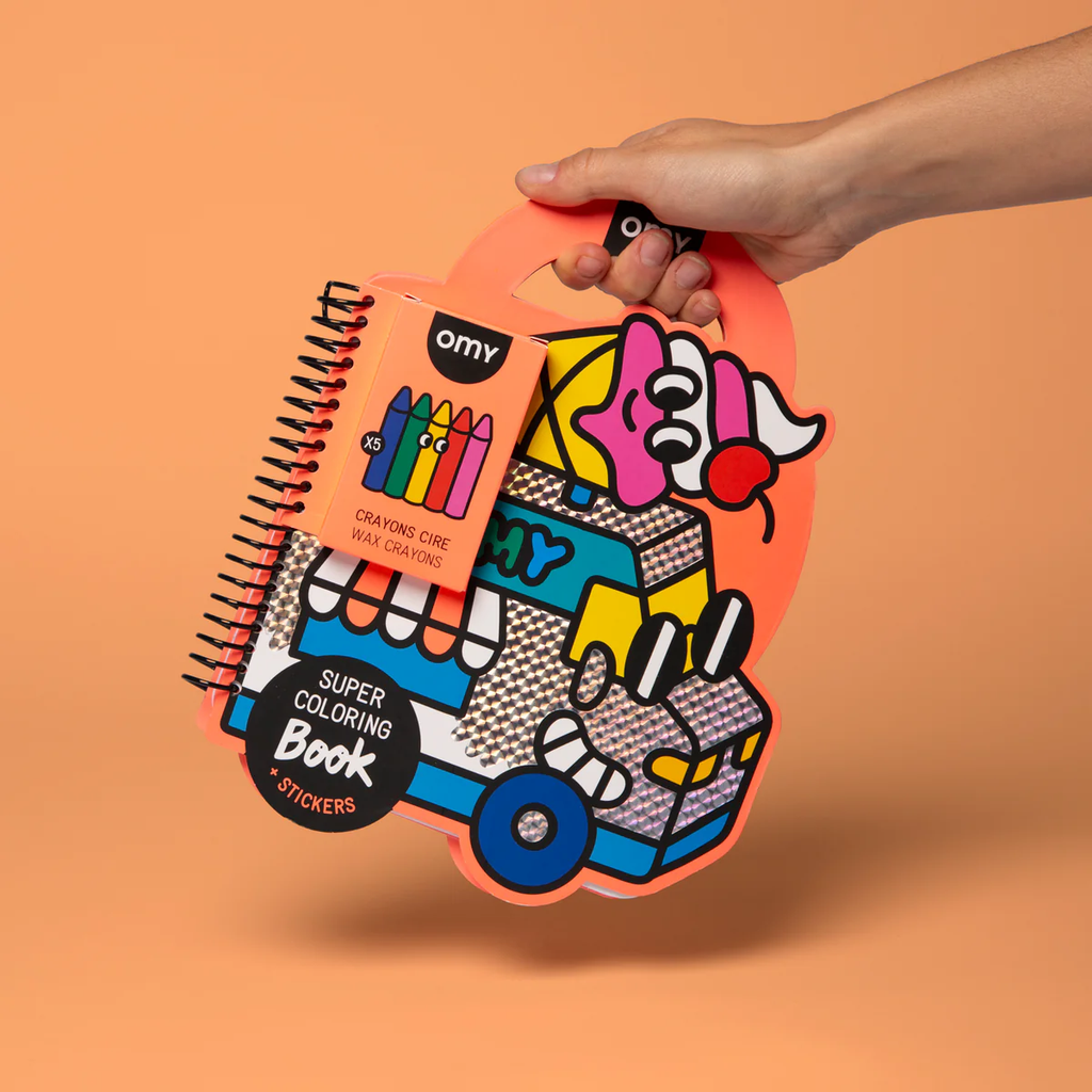 Hand holding a colorful packaging of a coloring book and crayons set on an orange background