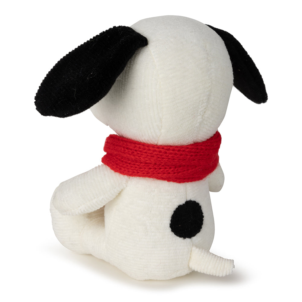 Stuffed dog toy with a red scarf on a white background