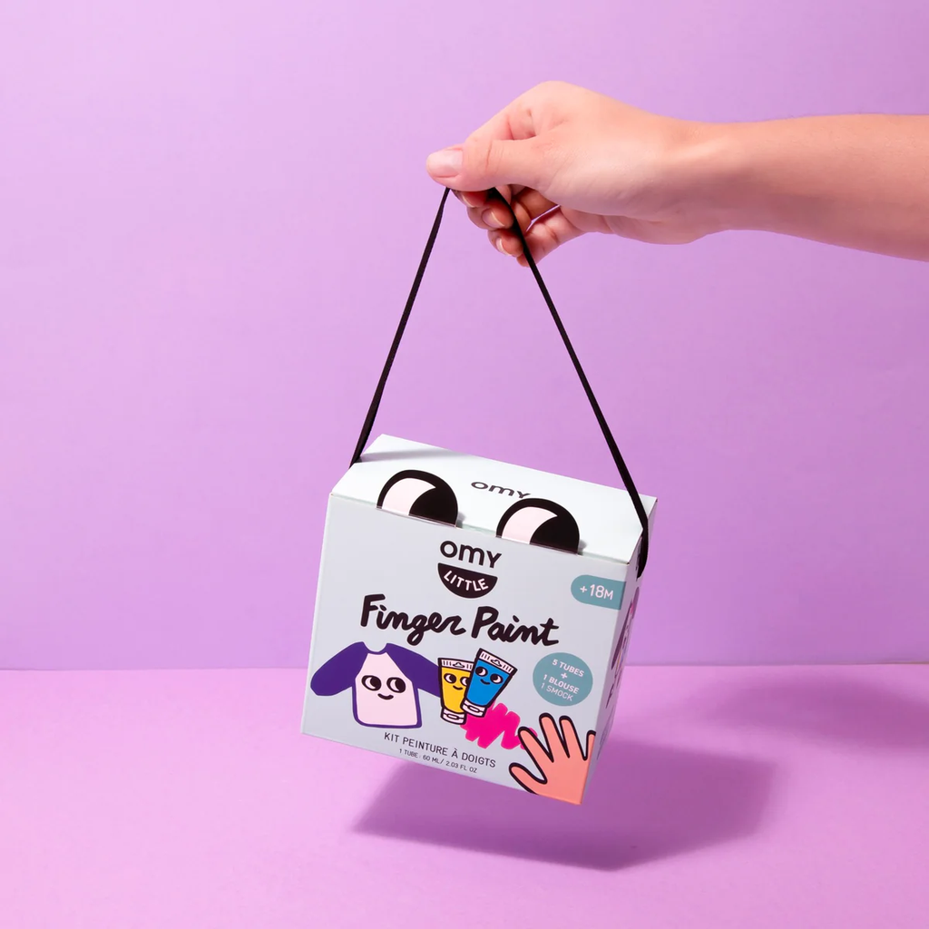 Box for paint kit held on purple background