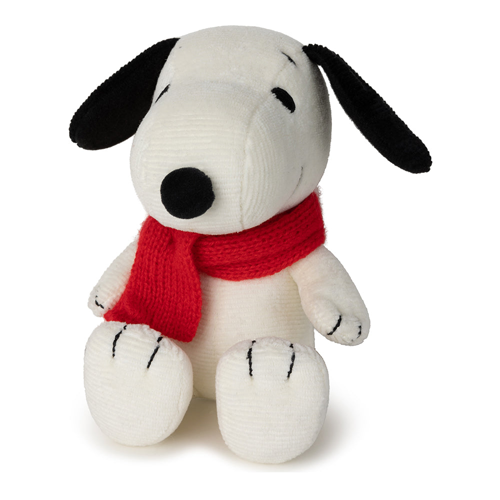Stuffed dog toy with a red scarf on a white background