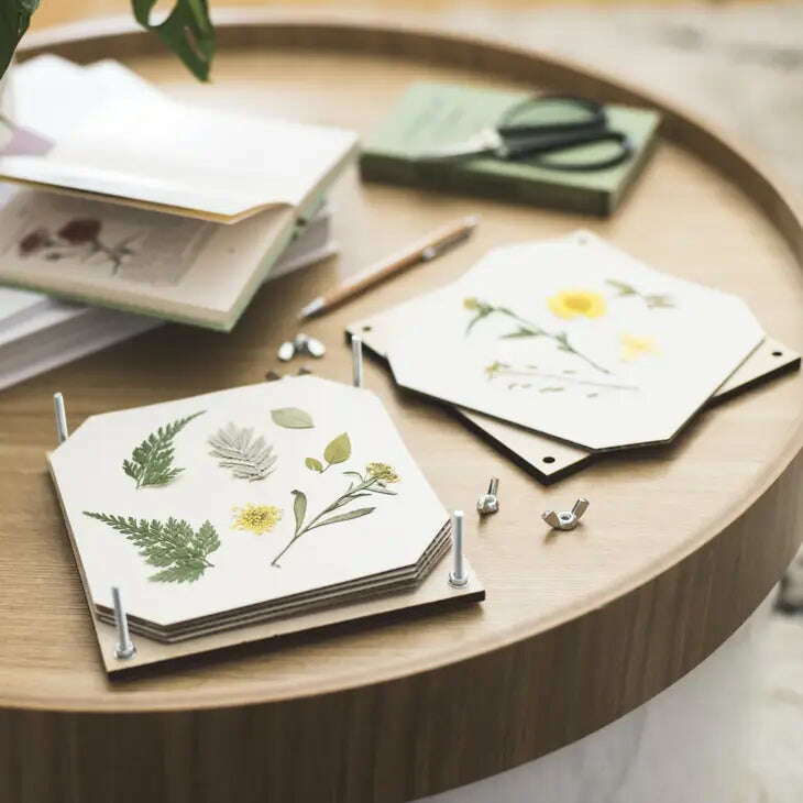 Hexagonal flower press with pressed plants on a wooden table