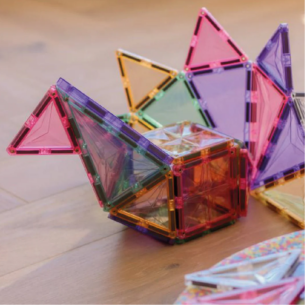 Colorful magnetic building blocks on a wooden surface