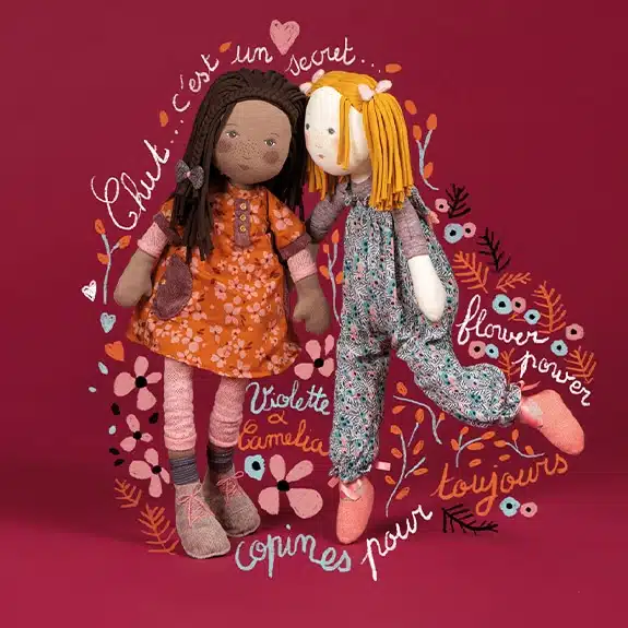 Two dolls with floral designs and text on a red background