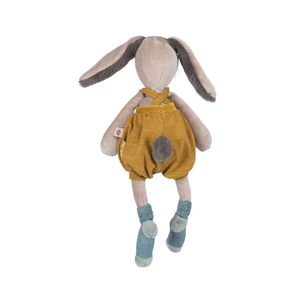 Plush toy rabbit wearing mustard yellow overalls on a white background