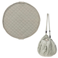 Quilted green bag with matching round cushion on a white background
