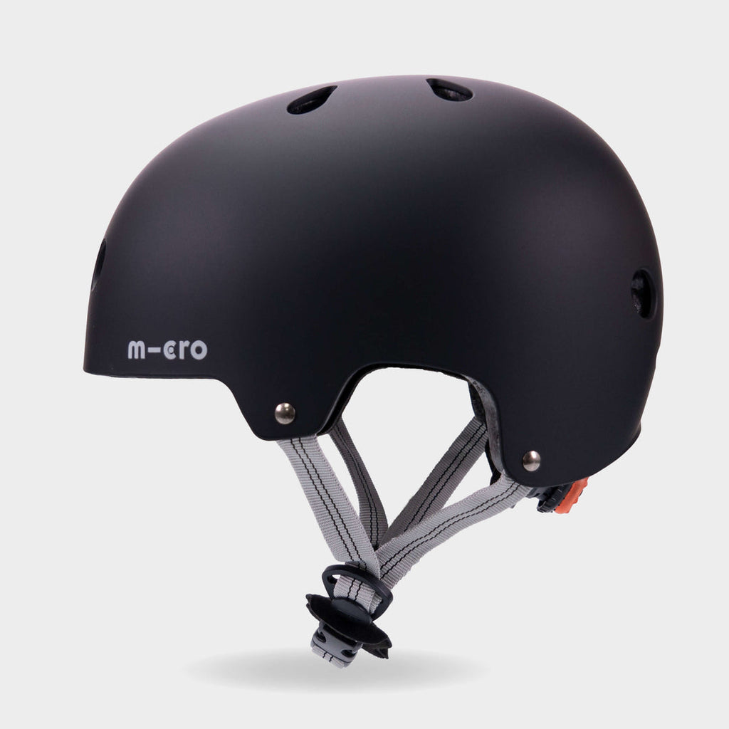 Side view of the black Micro plain kids' helmet showing the air vents