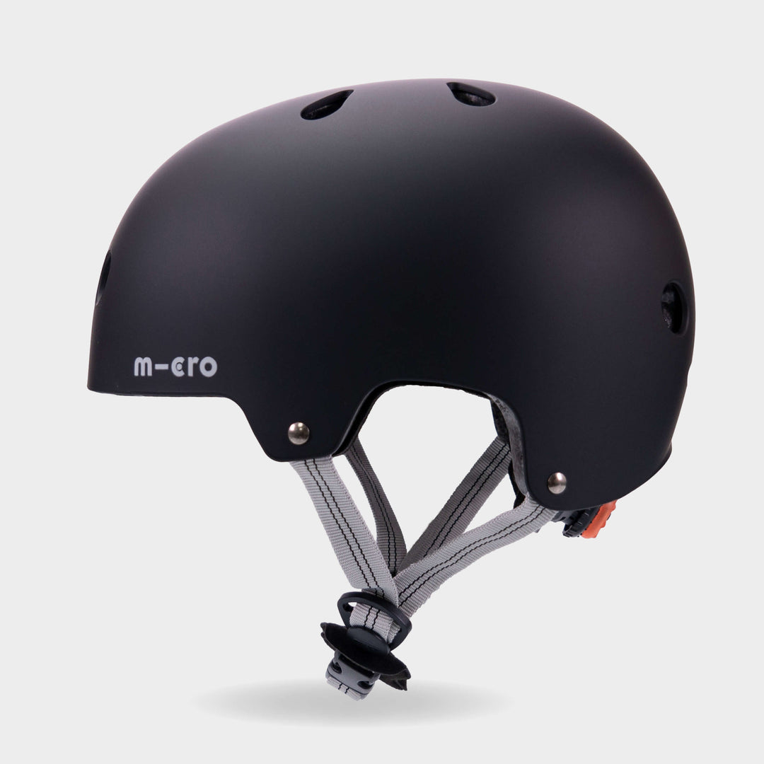 Side view of the black Micro plain kids' helmet showing the air vents