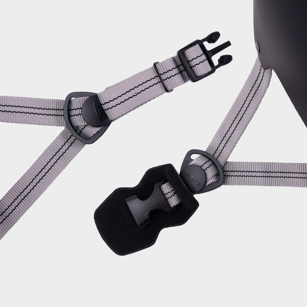 Close-up of the grey adjustable straps and black buckle on the Micro plain helmet