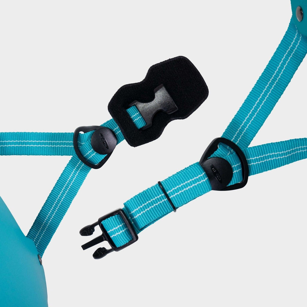 Close-up of the aqua adjustable straps and black buckle on the Micro plain helmet