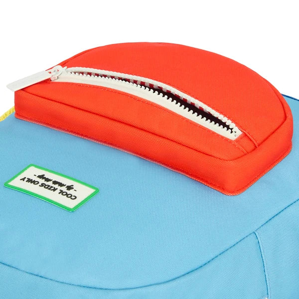 Close-up of a blue bag with an orange pouch on top, featuring a brand label.